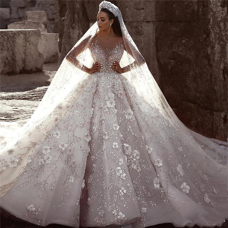 wedding dress with chapel train,wedding dress with long trains,wedding dress with rhinestones,wedding dress with 3d flowers,long sleeve illusion wedding dress,long sleeve wedding dress with long trains,long sleeved plus size wedding dress,wedding dress with lots of crystals,huge ball gown wedding dress with crystals,