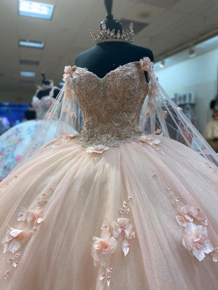 off the shoulder quinceanera dress,champagne colored quinceanera dress,quinceanera dress with cape,glitter houston quinceanera dress,glitter cape quinceanera dress,2021 quinceanera dress,blush pink quinceanera dress,quinceanera dress with 3d flowers,3d floral applique quinceanera dress,