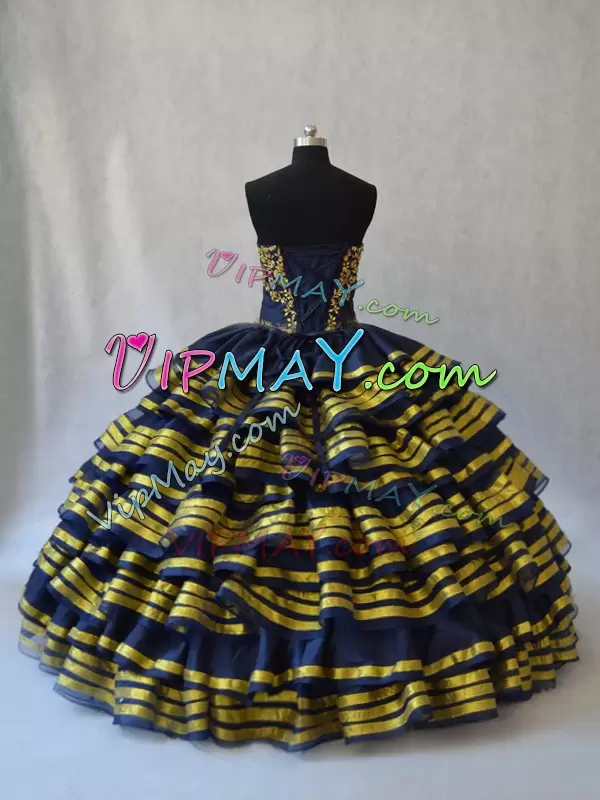 black and gold quinceanera dress,black quincenanera dress,sweetheart neckline quinceanera dress,floral embroidery quinceanera dress,ruffled layers quinceanera dress,quinceanera dress satin layers,black charro quinceanera dress,unique quinceanera dress,