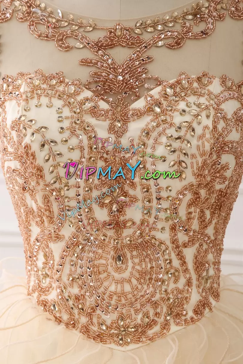quinceanera dress without people,champagne quinceanera dress with ruffles,beaded bodice quinceanera dress,sweet sixteen dress with ruffles,ruffled skirt sweet 16 dress,